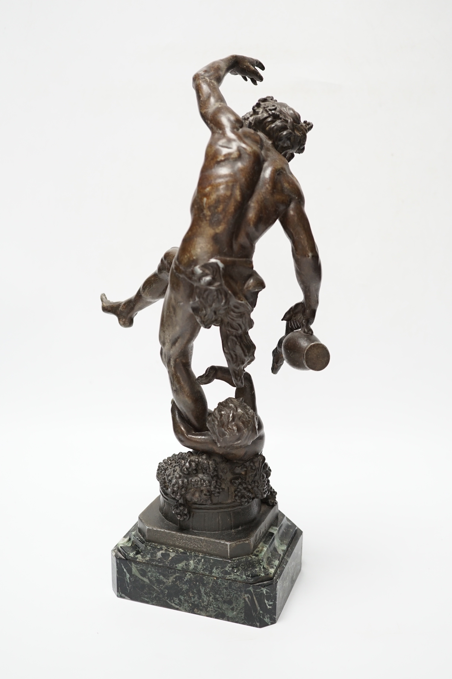 A bronzed spelter dancing figure of Bacchus - ‘Le Vin’, with a fawn and bunches of grapes, on a marble base, 36cm high